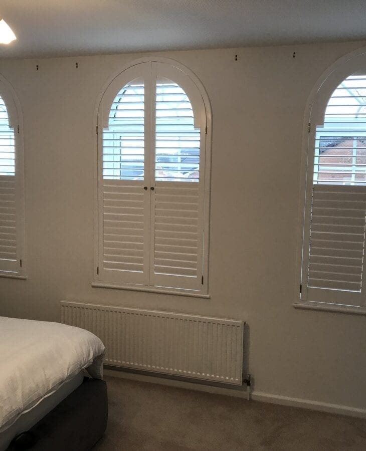 Plantation shutters in a bedroom