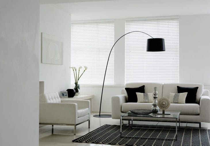 Gloss white venetian blinds in monochrome livingroom