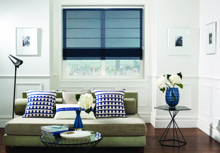 Modern living room with dark blue motorised blinds for windows, stylish sofa and contemporary décor