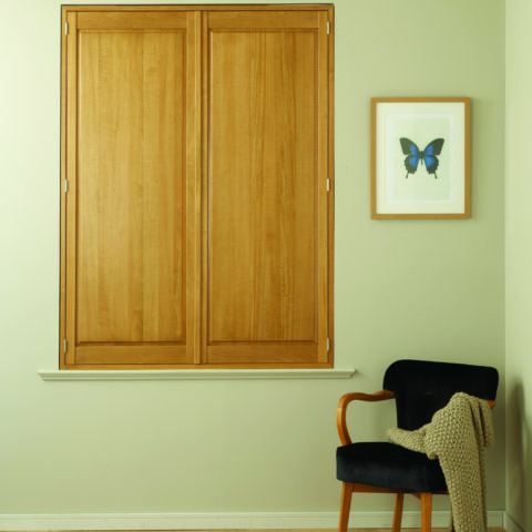 Solid Oak plantation shutter in a living room