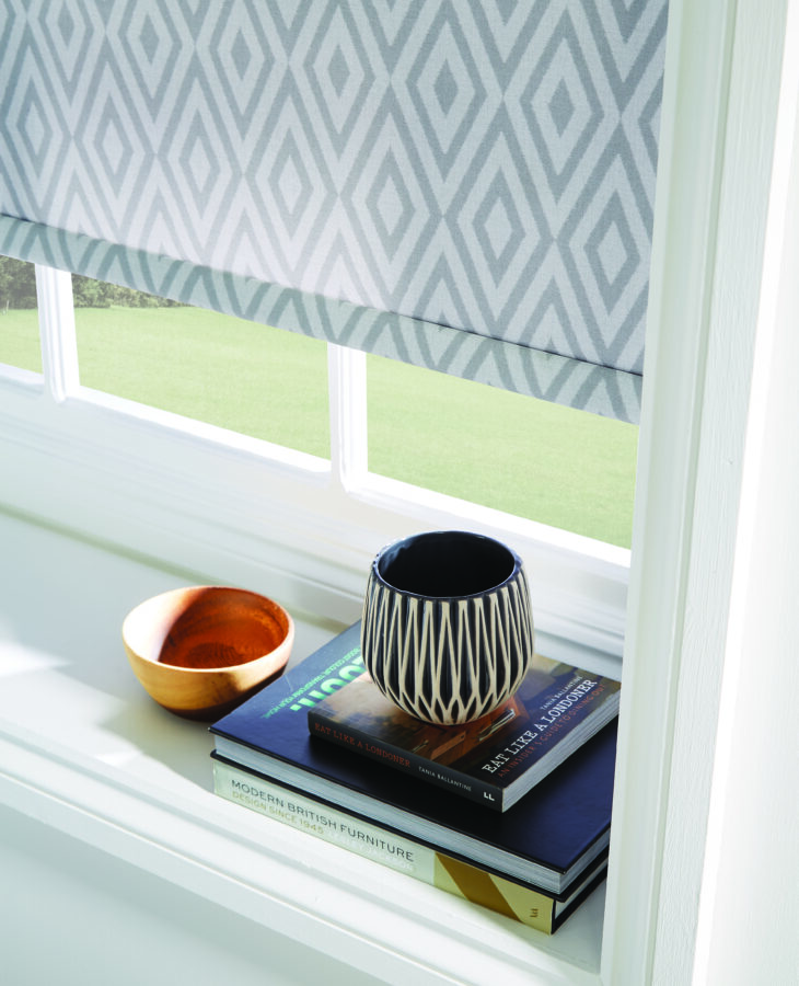 window-ledge-with-books-and-aztec-roller-blinds