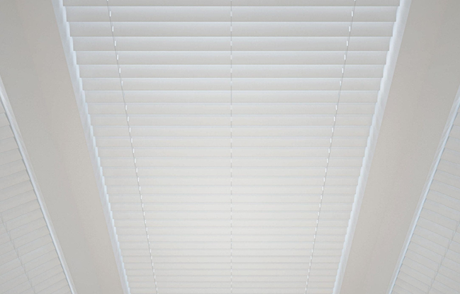 White waterproof Venetian blinds fully closed on a bathroom window, providing full privacy.