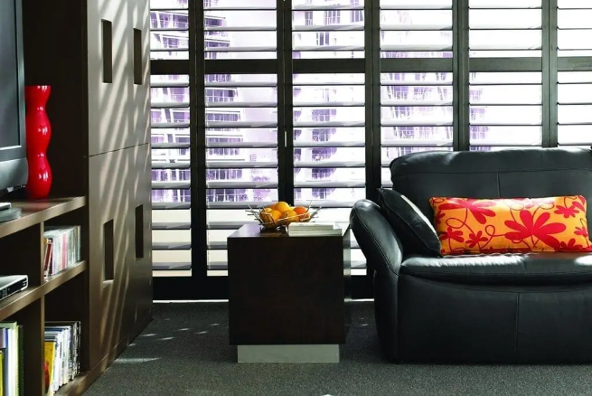 black walnut wooden shutters in a contemporary Morley living room with leather sofa and modern decor