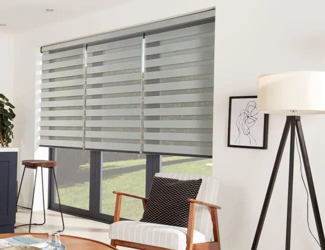 modern living room with large windows fitted with stylish grey day and night blinds