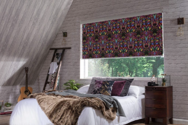 colourful blackout roller blind with rainbow pattern in a modern loft bedroom with rustic decor