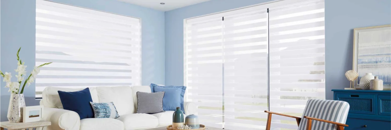 White vertical blinds in a bright UK living room with blue walls