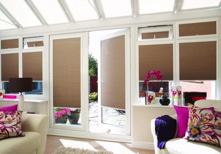 bright conservatory in Horbury with brown cellular blinds and floral decor