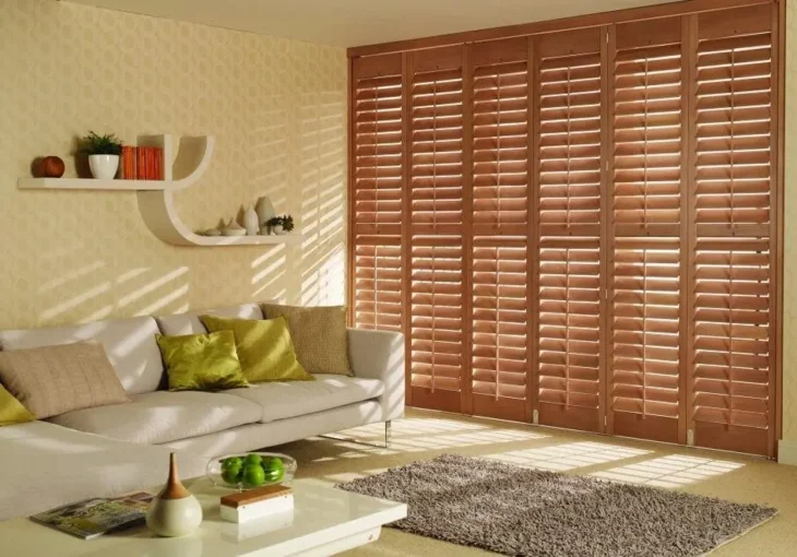 living room in Horbury with wooden plantation shutters and neutral decor letting in warm natural light