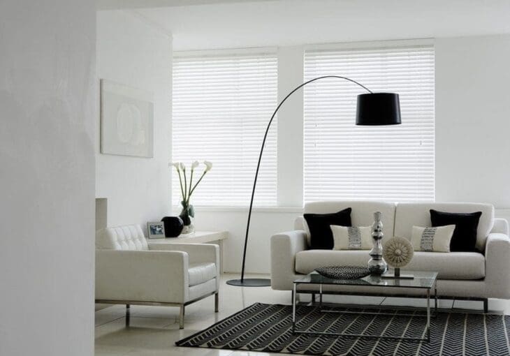modern living room in Ossett with white wooden blinds and monochrome decor