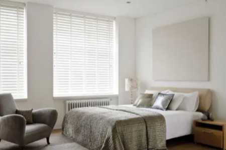 Wooden blinds in bedroom creating privacy and comfort