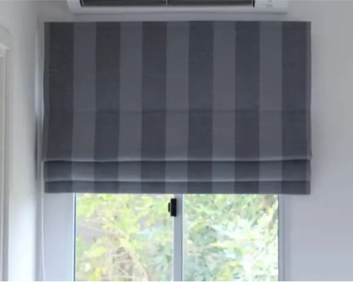 Roman blind with pleated fabric showing smooth folded design