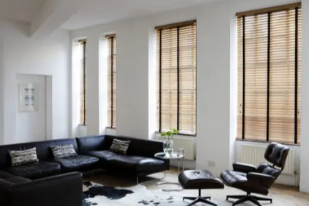 Wooden blinds in living room providing light control and privacy